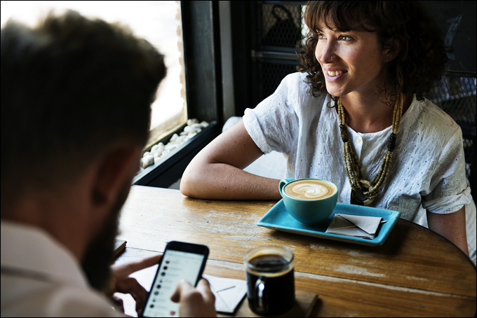 Image: man and woman at a coffee shop.